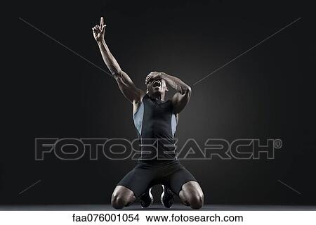 Male athlete shouting with finger pointing up View Large Photo Image Picture - Male athlete shouting with finger pointing up. Fotosearch