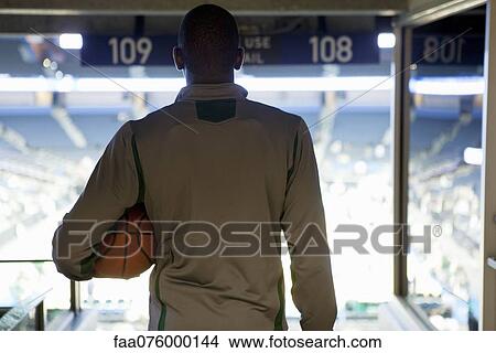 Picture - Man looking down at stadium, rear view. Fotosearch