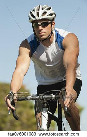 Stock Image - Man riding bicycle, portrait. Fotosearch