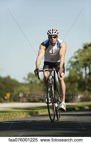 Stock Photography - Man riding bicycle. Fotosearch
