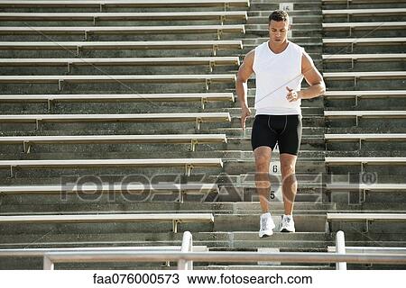 Stock Image - Man running down stadium steps. Fotosearch