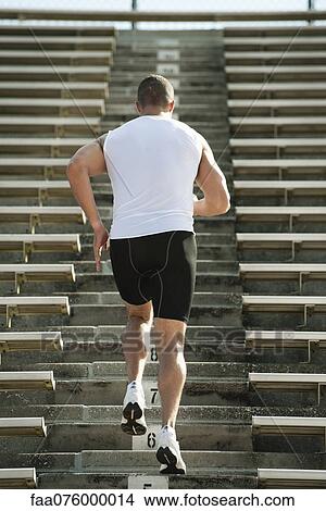 Man running up steps in stadium, rear view View Large Photo Image Picture - Man running up steps in stadium, rear view. Fotosearch