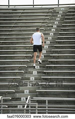 Man running up steps in stadium, rear view View Large Photo Image Stock Image - Man running up steps in stadium, rear view. Fotosearch