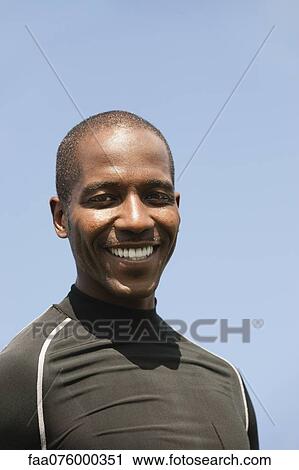 Stock Image - Man smiling at camera, portrait. Fotosearch
