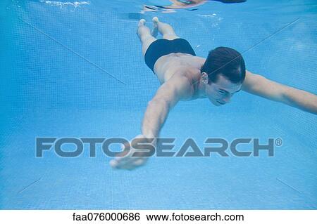 Stock Photograph - Man swimming underwater. Fotosearch