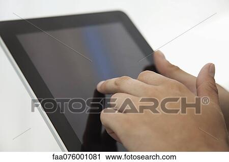 Stock Image - Man using digital tablet, cropped. Fotosearch