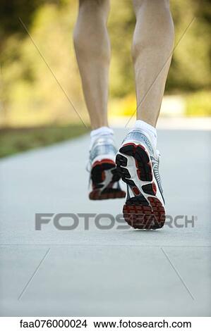 Picture - Man walking, cropped rear view. Fotosearch