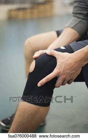 Man wearing knee brace, cropped View Large Photo Image Stock Photo - Man wearing knee brace, cropped. Fotosearch