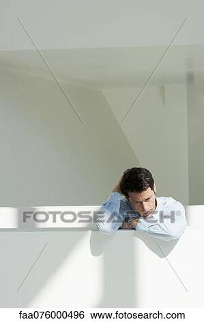 Stock Photograph - Mature man looking downward. Fotosearch