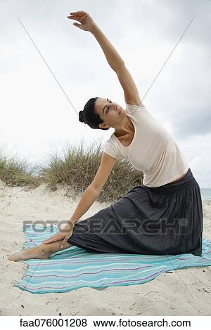 Mature woman doing yoga stretch on beach, portrait View Large Photo Image Stock Photo - Mature woman doing yoga stretch on beach, portrait. Fotosearch