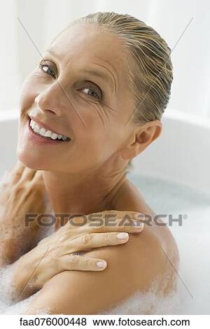 Mature woman enjoying bubble bath View Large Photo Image Stock Photo - Mature woman enjoying bubble bath. Fotosearch
