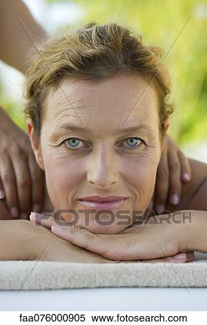Stock Photography - Mature woman getting massage, portrait. Fotosearch