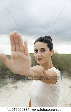 Picture - Mature woman holding up hand, selective focus. Fotosearch