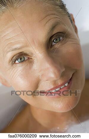 Stock Photo - Mature woman in bath, cropped. Fotosearch