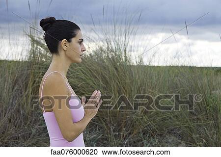 Mature woman in prayer position outdoors, side view View Large Photo Image Stock Image - Mature woman in prayer position outdoors, side view. Fotosearch