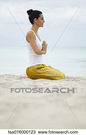 Mature woman kneeling in prayer position on beach, side view View Large Photo Image Stock Image - Mature woman kneeling in prayer position on beach, side view. Fotosearch