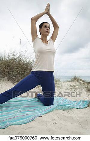 Mature woman practicing yoga on beach, low angle view View Large Photo Image Stock Image - Mature woman practicing yoga on beach, low angle view. Fotosearch
