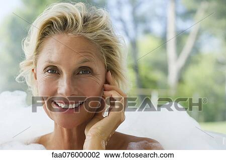 Mature woman relaxing in bubble bath, portrait View Large Photo Image Stock Image - Mature woman relaxing in bubble bath, portrait. Fotosearch