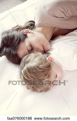 Mother napping with young son View Large Photo Image Stock Photo - Mother napping with young son. Fotosearch