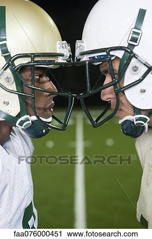 Opposing football players facing off View Large Photo Image Stock Image - Opposing football players facing off. Fotosearch
