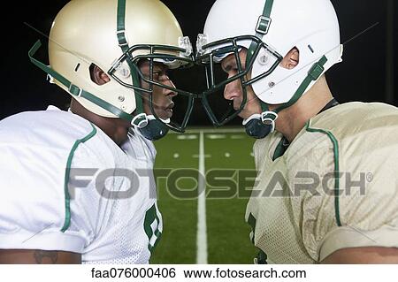 Opposing football players facing off View Large Photo Image Stock Photograph - Opposing football players facing off. Fotosearch