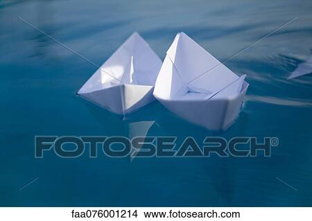 Picture - Paper boat floating on water. Fotosearch
