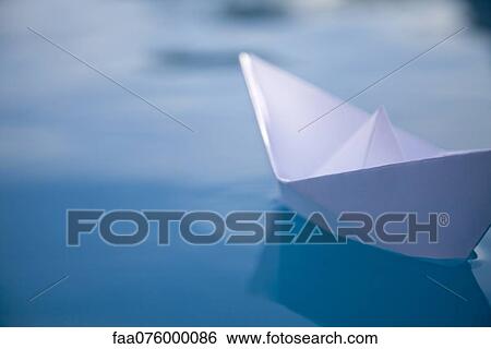 Paper boat floating on water View Large Photo Image Stock Photograph - Paper boat floating on water. Fotosearch