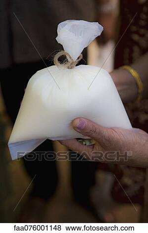 Person holding lassi in plastic bag View Large Photo Image Stock Photo - Person holding lassi in plastic bag. Fotosearch