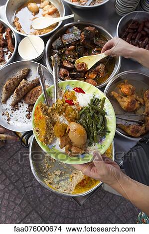 Person serving prepared street food View Large Photo Image Picture - Person serving prepared street food. Fotosearch