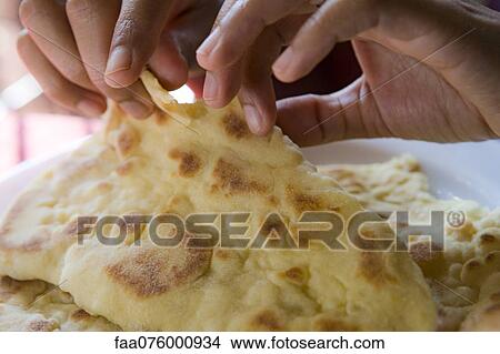 Person tearing naan View Large Photo Image Picture - Person tearing naan. Fotosearch