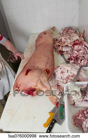 Stock Photo - Pork leg and parts on butcher's counter. Fotosearch