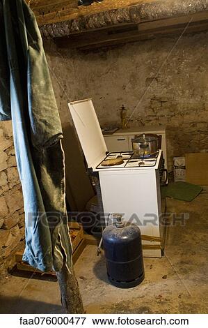 Stock Photo - Pot cooking on gas stove in rustic room. Fotosearch