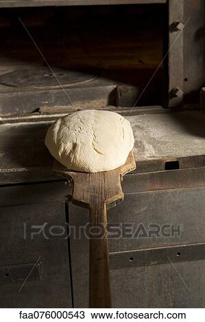 Putting unbaked bread into oven View Large Photo Image Stock Image - Putting unbaked bread into oven. Fotosearch