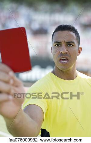 Stock Image - Referee holding red card. Fotosearch