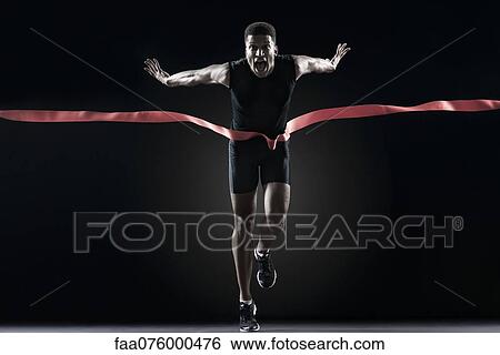 Stock Photograph - Runner crossing finishing line. Fotosearch