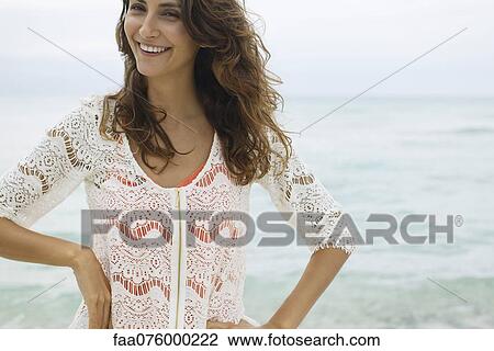 Stock Image - Smiling young woman, cropped. Fotosearch