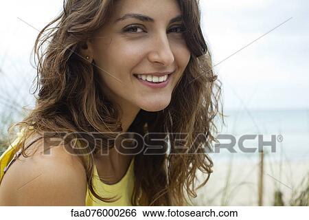 Smiling young woman outdoors, portrait View Large Photo Image Stock Photograph - Smiling young woman outdoors, portrait. Fotosearch