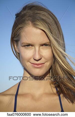 Stock Image - Smiling young woman, portrait. Fotosearch