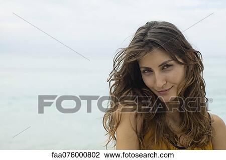 Stock Image - Smiling young woman, portrait. Fotosearch