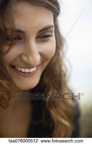 Stock Image - Smiling young woman. Fotosearch
