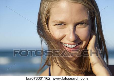 Smiling young woman with tousled hair, portrait View Large Photo Image Stock Image - Smiling young woman with tousled hair, portrait. Fotosearch