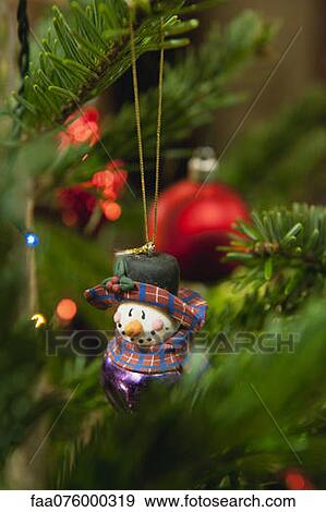 Snowman ornament hanging on Christmas tree View Large Photo Image Stock Photo - Snowman ornament hanging on Christmas tree. Fotosearch