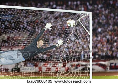 Soccer goalkeeper diving to block ball View Large Photo Image Stock Photography - Soccer goalkeeper diving to block ball. Fotosearch