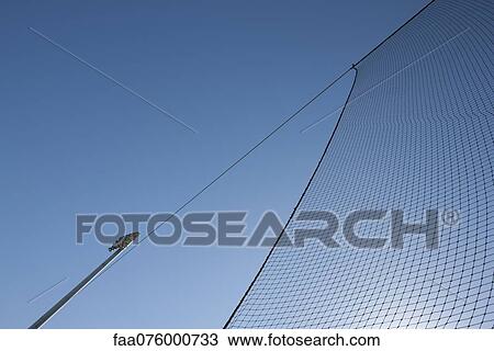Stock Image - Sports net against blue sky. Fotosearch