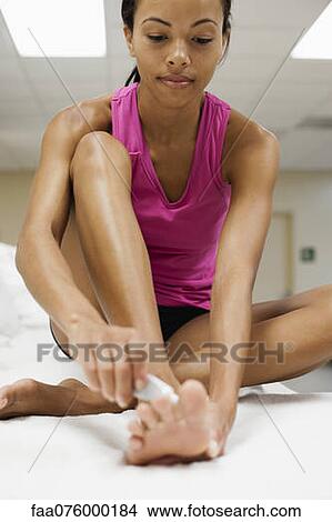 Woman applying ointment on foot View Large Photo Image Picture - Woman applying ointment on foot. Fotosearch
