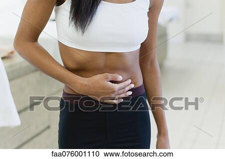 Woman experiencing abdominal pain, mid section View Large Photo Image Stock Image - Woman experiencing abdominal pain, mid section. Fotosearch