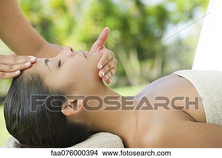 Woman getting a face massage View Large Photo Image Picture - Woman getting a face massage. Fotosearch