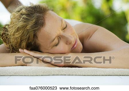 Stock Image - Woman getting a massage at spa. Fotosearch