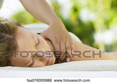 Stock Photo - Woman getting a massage at spa. Fotosearch
