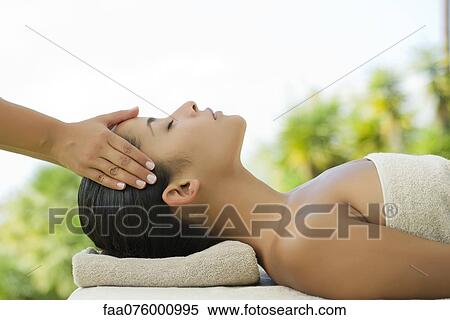 Stock Photography - Woman getting a massage at spa. Fotosearch